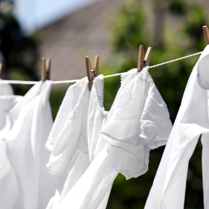 Clean clothes hanging on washing line in garden, closeup. Drying laundry. © New Africa/Shutterstock